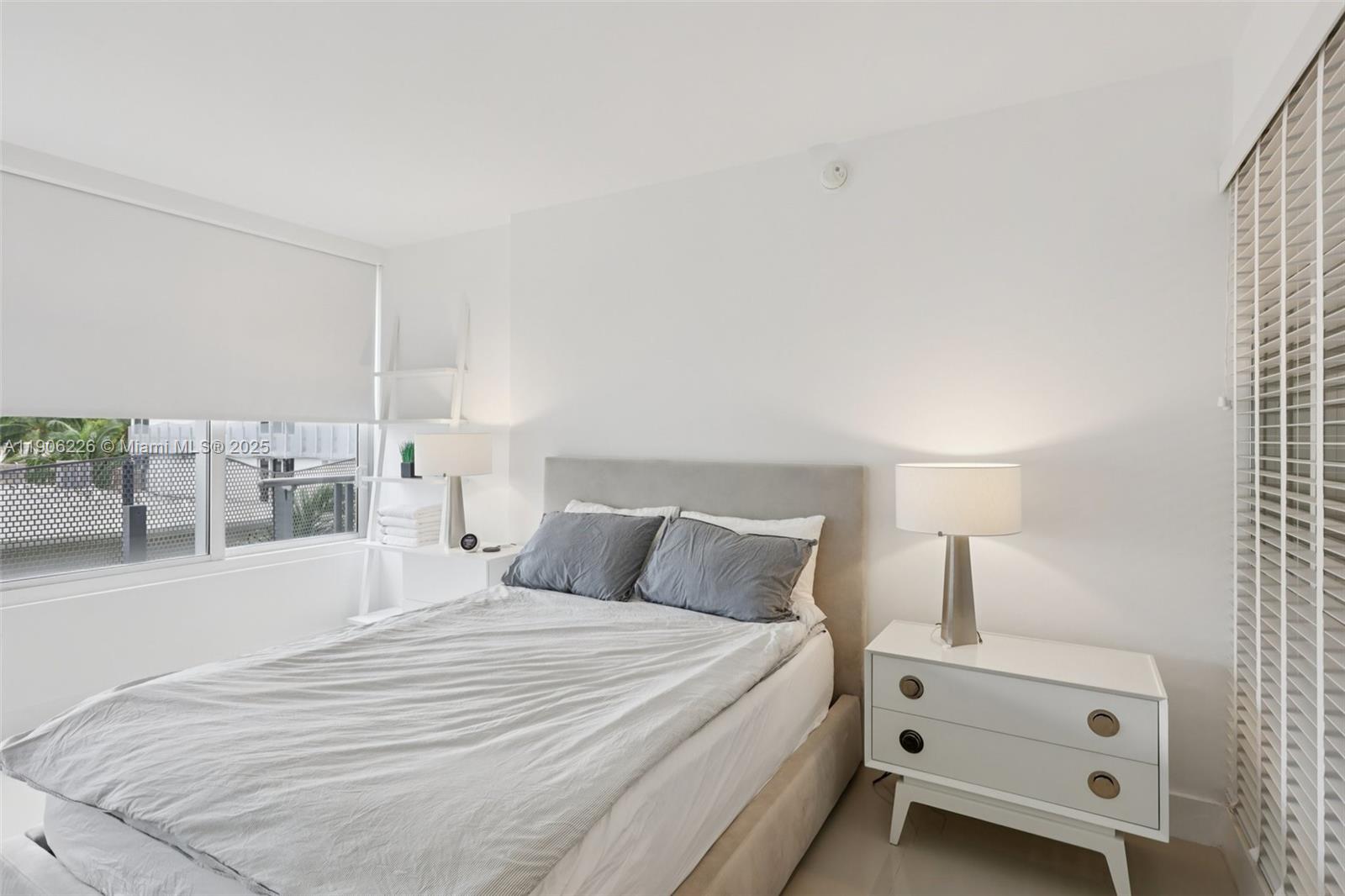 2155 Washington Court, Unit 303 Miami Beach, FL 33139 - Photo 16 of 35 a bedroom with a bed and a window