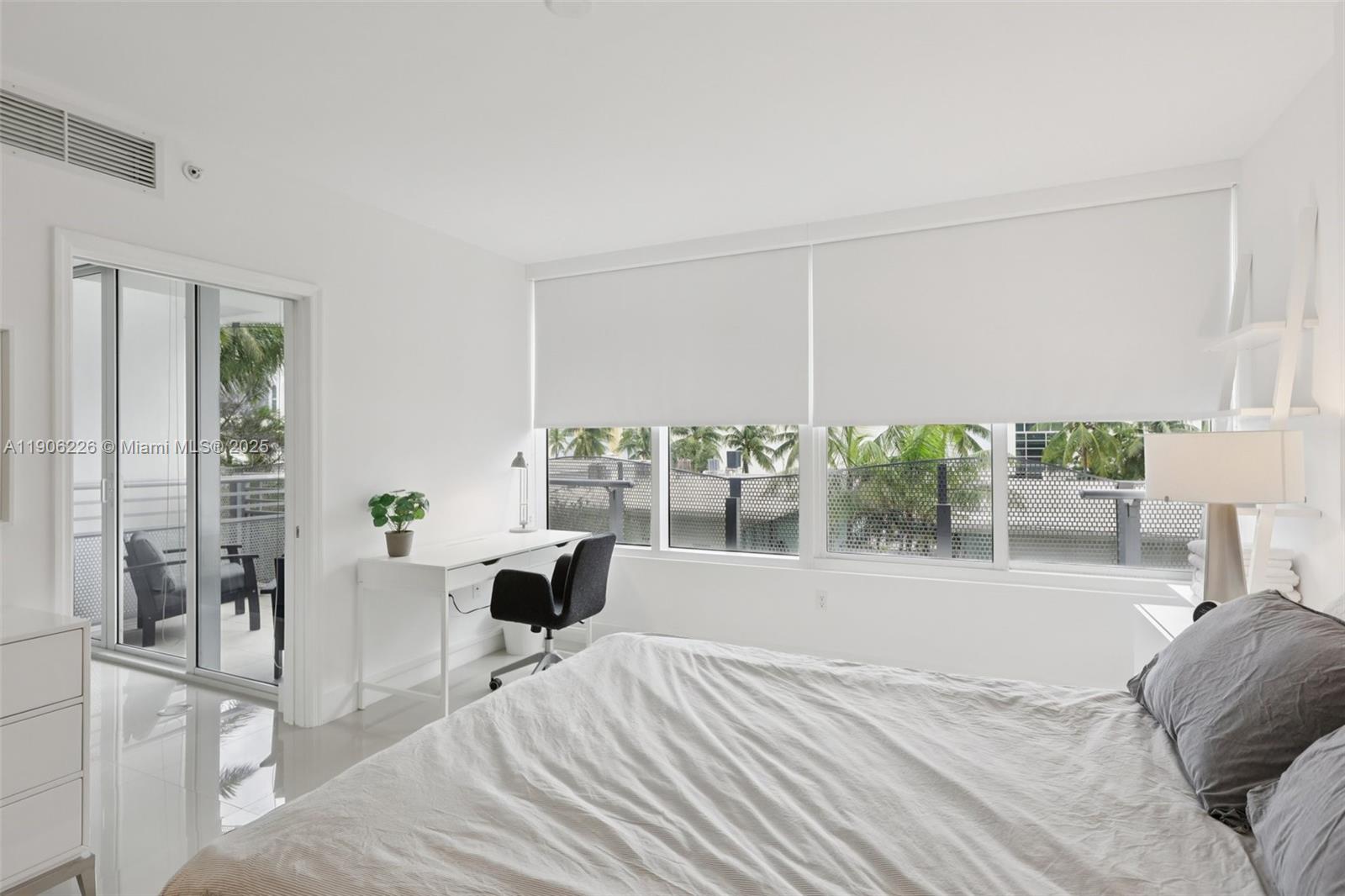 2155 Washington Court, Unit 303 Miami Beach, FL 33139 - Photo 18 of 35 a bedroom with furniture and large windows