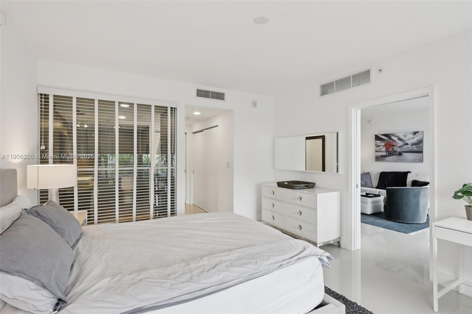 2155 Washington Court, Unit 303 Miami Beach, FL 33139 - Photo 20 of 35 a bedroom with a bed and a large window