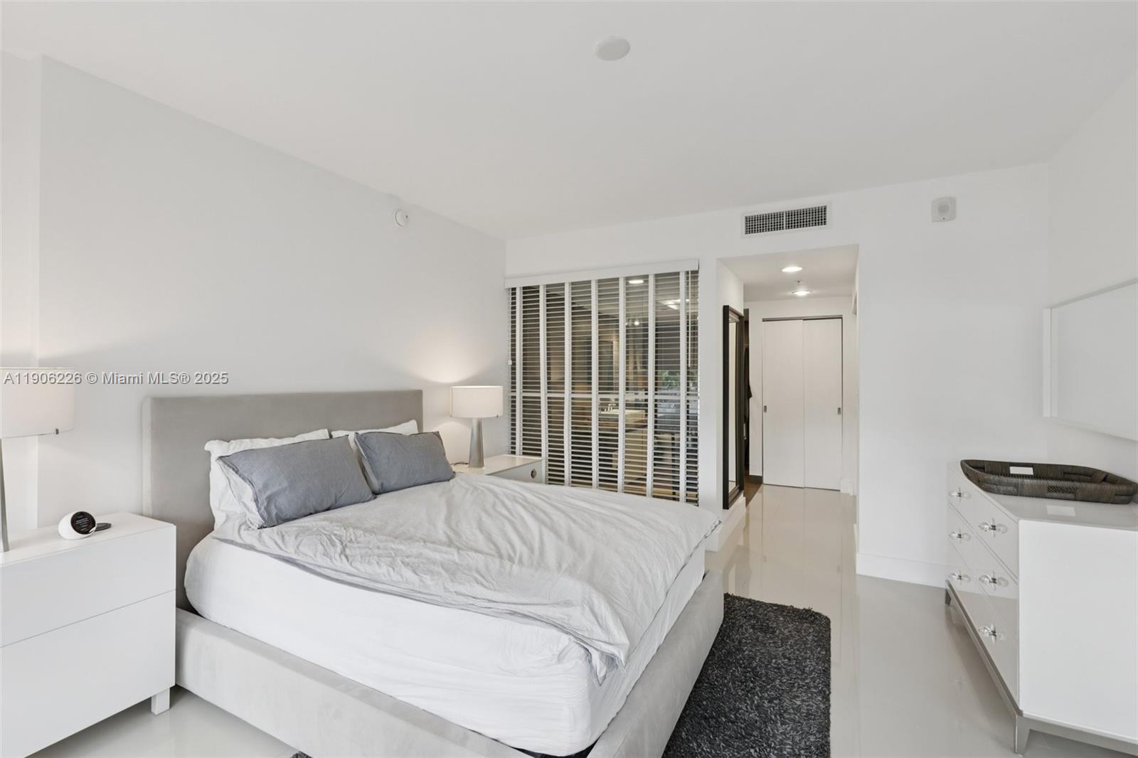 2155 Washington Court, Unit 303 Miami Beach, FL 33139 - Photo 21 of 35 a bedroom with a bed and a window
