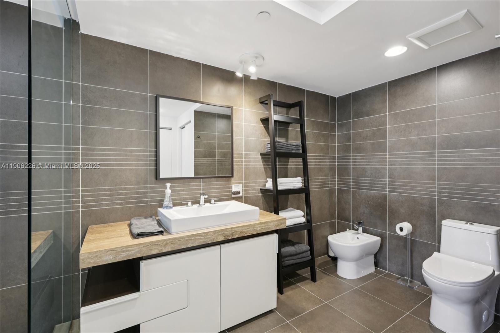 2155 Washington Court, Unit 303 Miami Beach, FL 33139 - Photo 22 of 35 a bathroom with a sink toilet and shower