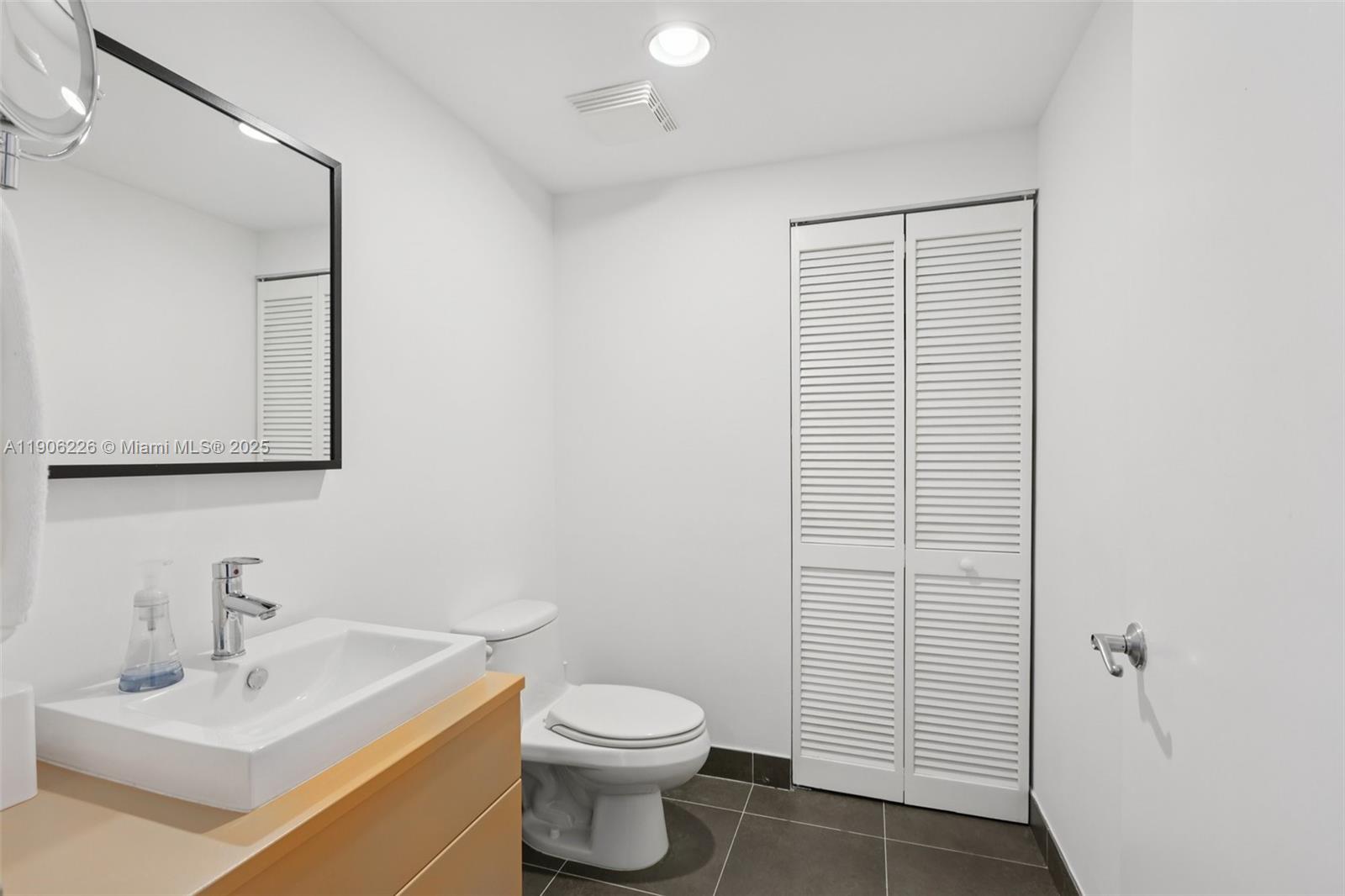 2155 Washington Court, Unit 303 Miami Beach, FL 33139 - Photo 26 of 35 a bathroom with a sink a toilet and shower