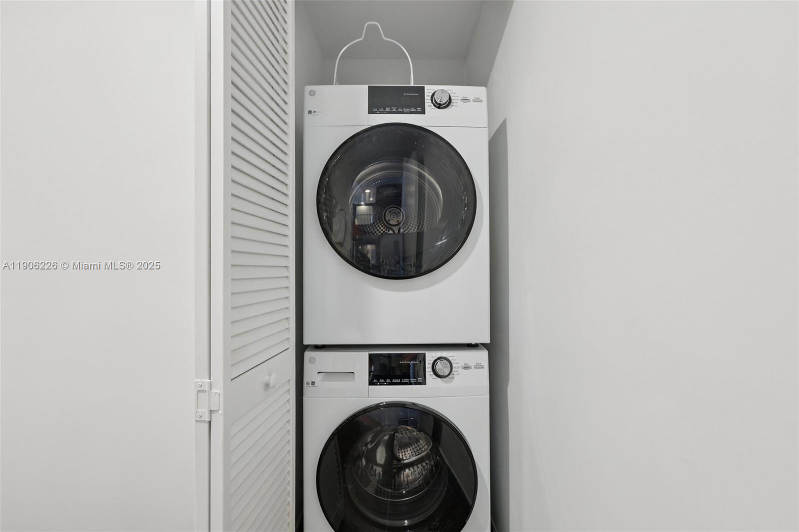 2155 Washington Court, Unit 303 Miami Beach, FL 33139 - Photo 27 of 35 a utility room with dryer and washer