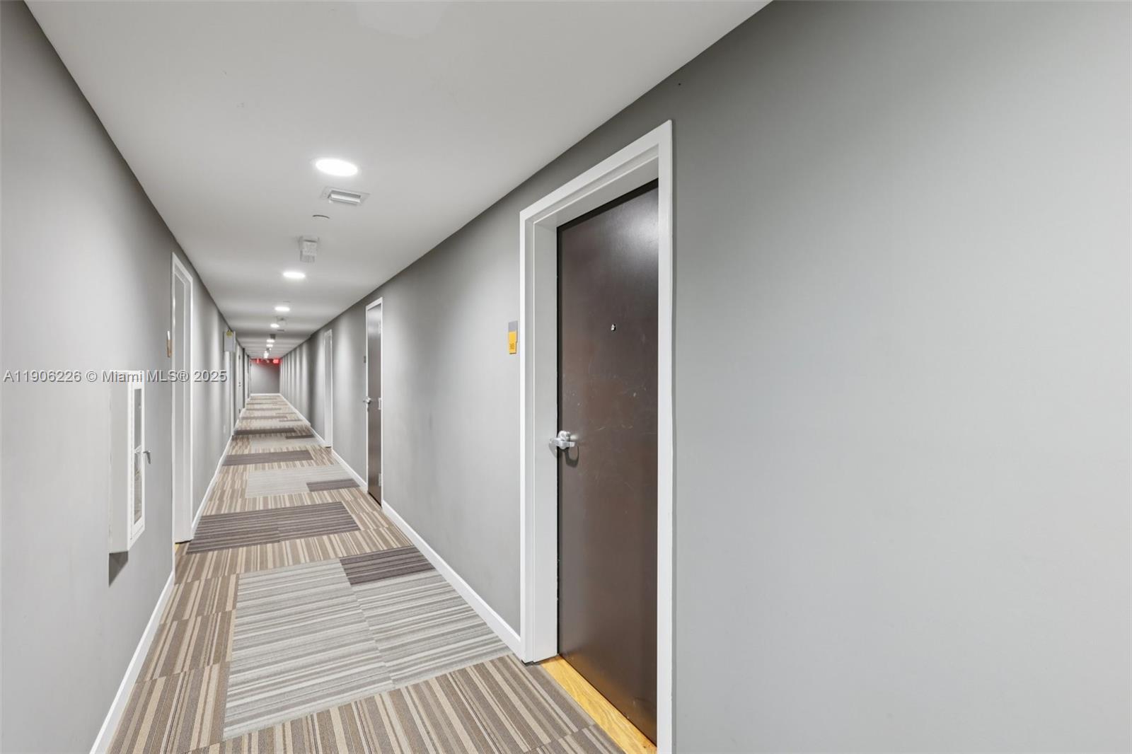 2155 Washington Court, Unit 303 Miami Beach, FL 33139 - Photo 4 of 35 a view of a hallway with wooden floor and staircase