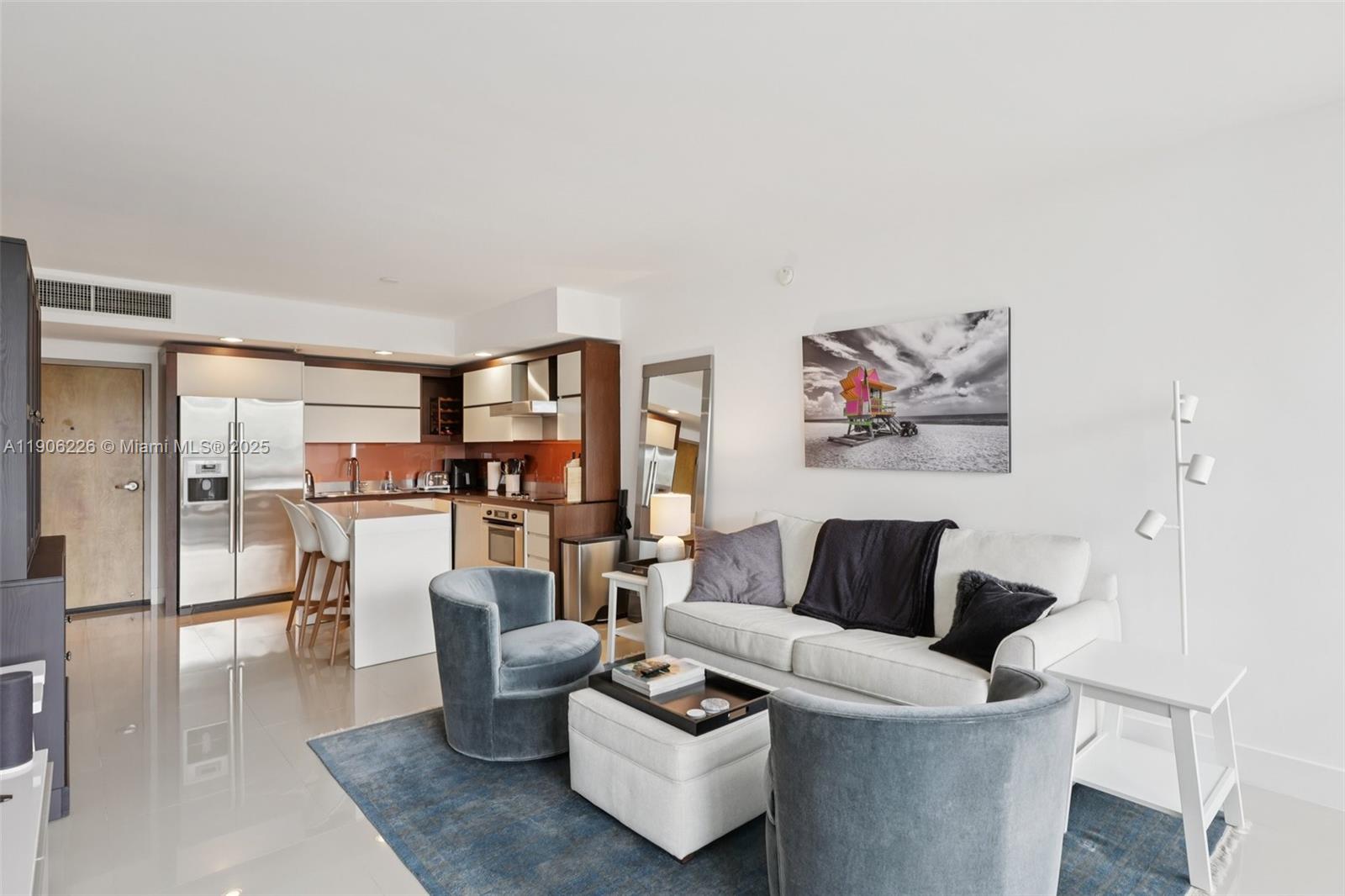 2155 Washington Court, Unit 303 Miami Beach, FL 33139 - Photo 7 of 35 a living room with furniture and a wooden floor