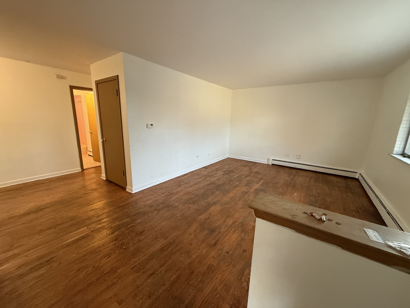 558 North Ardmore Avenue, Unit 2W Villa Park, IL 60181 - Photo 2 of 7 an empty room with wooden floor