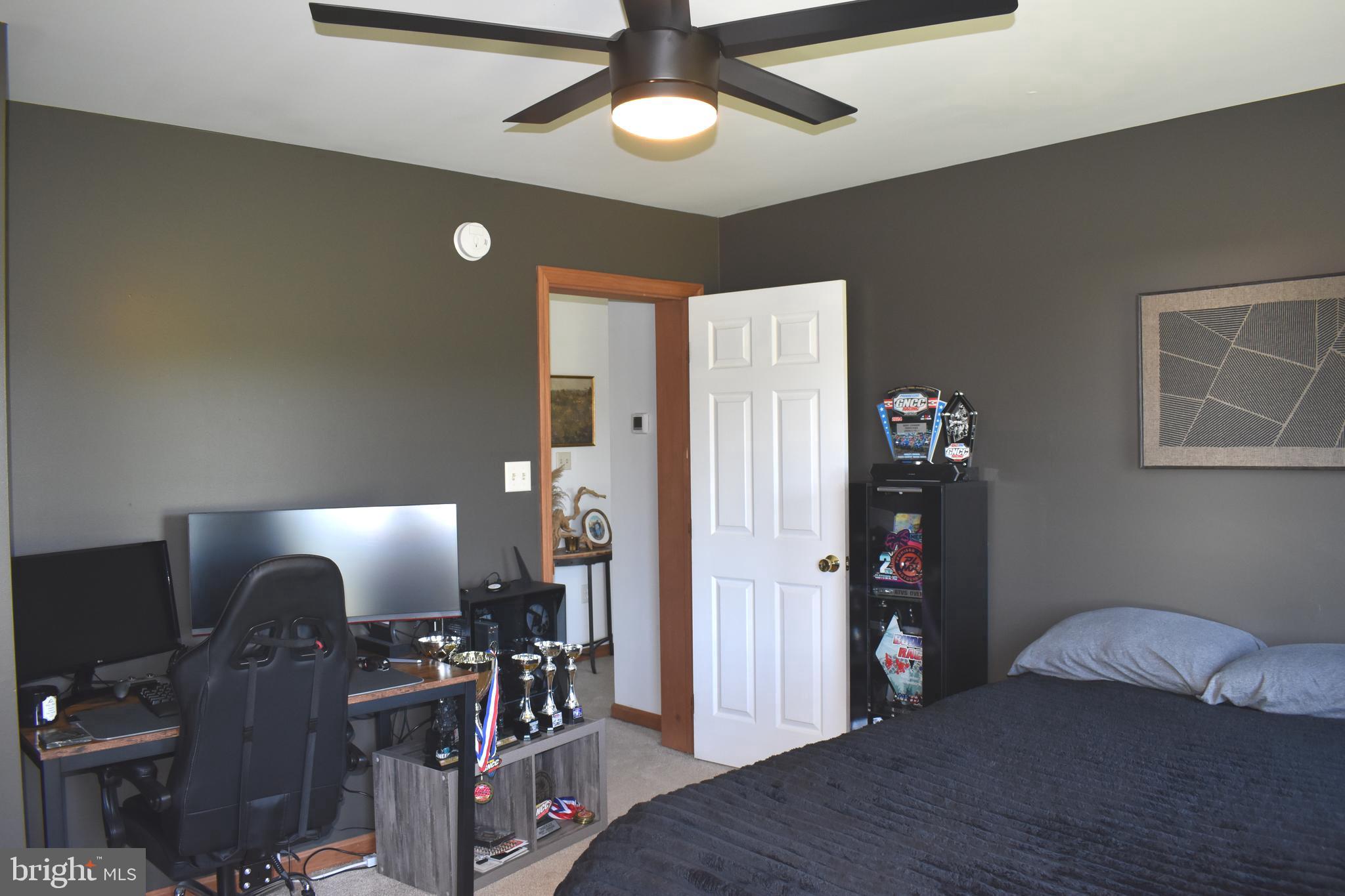 16621 Lappans Road Williamsport, MD 21795 - Photo 41 of 79 a bedroom with furniture and a chandelier