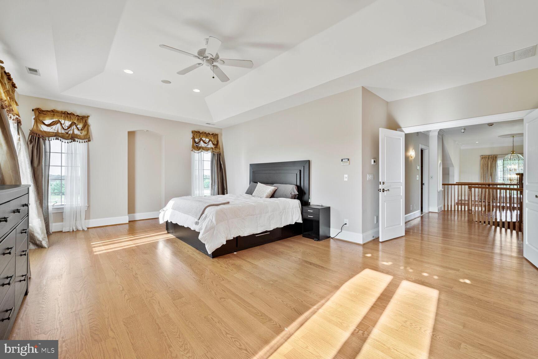 230 Point Airy Road Pilesgrove, NJ 08098 - Photo 51 of 78 a spacious bedroom with a large bed a chandelier and windows