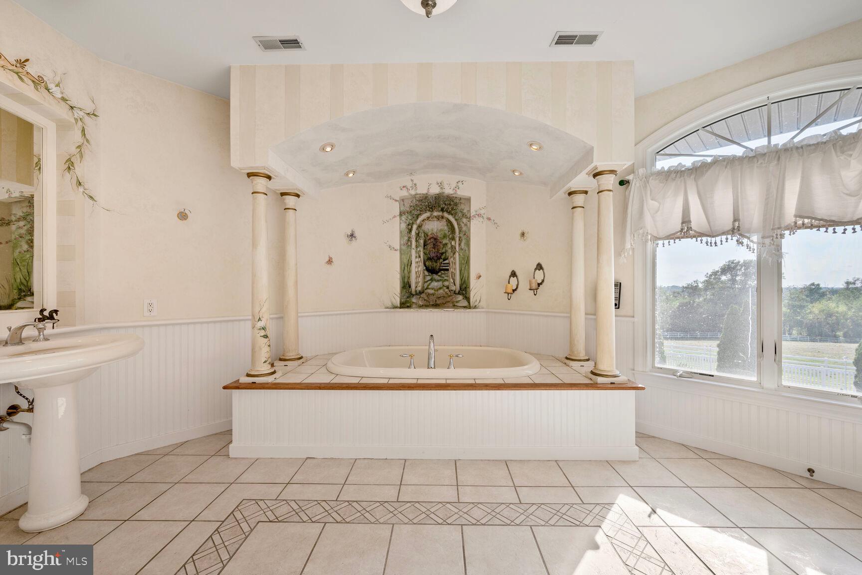 230 Point Airy Road Pilesgrove, NJ 08098 - Photo 53 of 78 a spacious bathroom with a tub a double vanity sink a mirror and next to a window