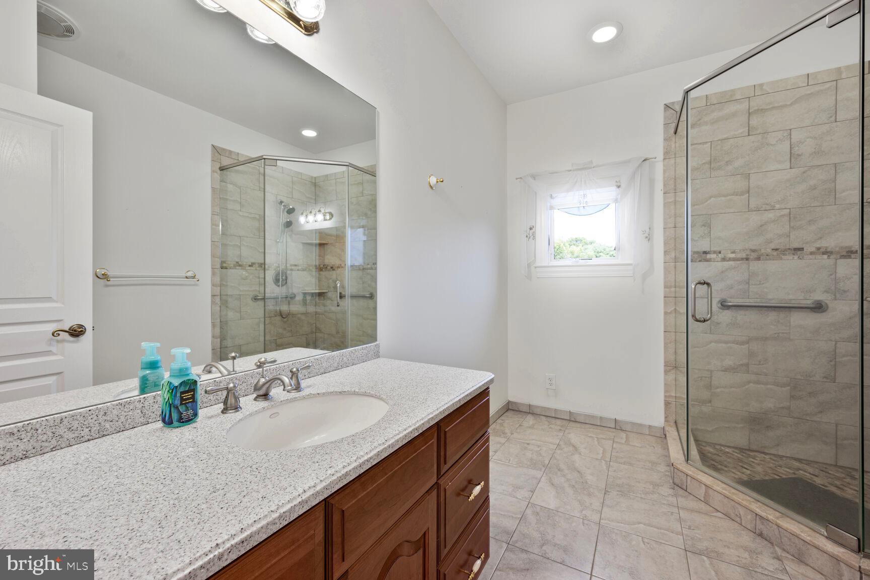 230 Point Airy Road Pilesgrove, NJ 08098 - Photo 56 of 78 a bathroom with a granite countertop sink a mirror and shower