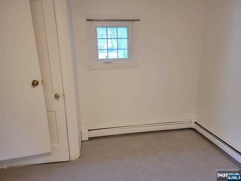 295 Lincoln Avenue Ridgewood, NJ 07450 - Photo 8 of 17 an empty room with a window