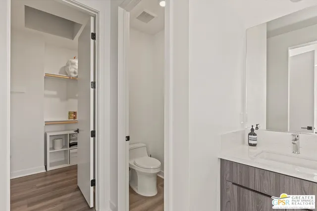 a bathroom with a granite countertop sink a toilet and shower