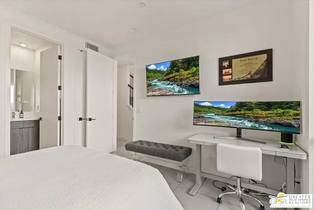 a bedroom with a bed and a desk