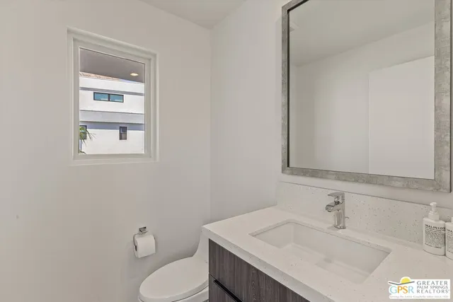 a bathroom with a sink toilet and vanity