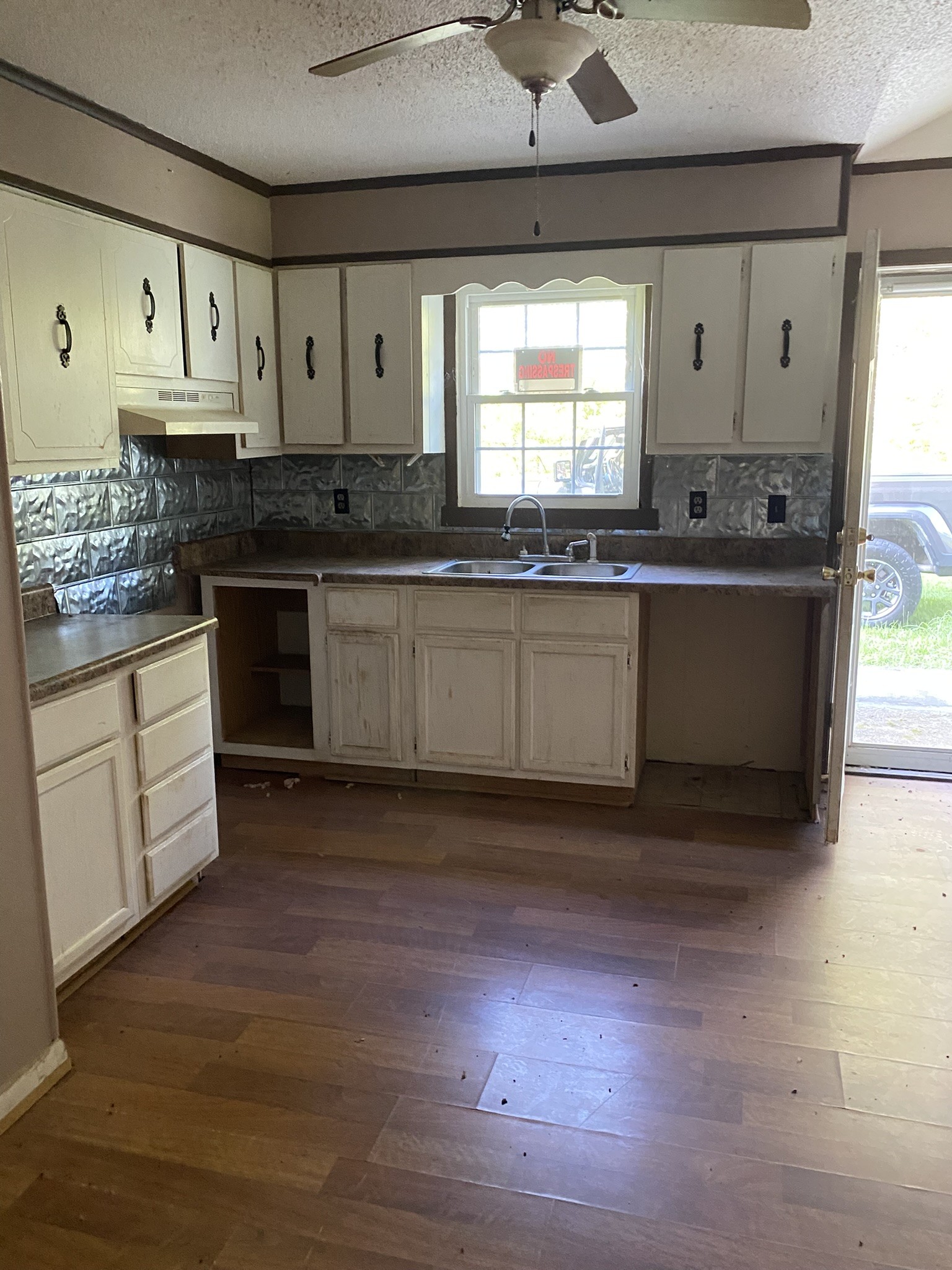 972 Fall River Road Goodspring, TN 38460 - Photo 29 of 31 a large kitchen with granite countertop a stove a sink a refrigerator and white cabinets with wooden floor
