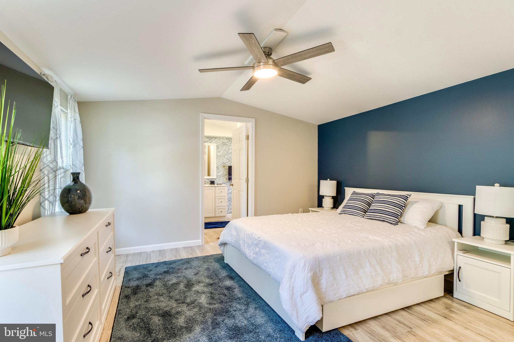 21263 K Street, Unit 37217 Rehoboth Beach, DE 19971 - Photo 23 of 49 a bedroom with a bed and a flat screen tv
