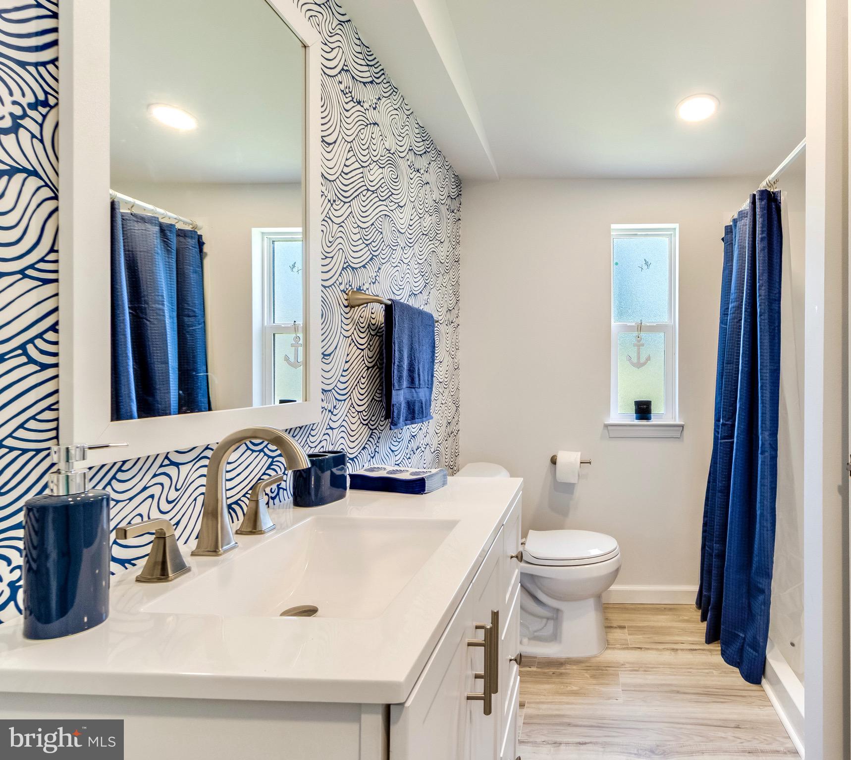 21263 K Street, Unit 37217 Rehoboth Beach, DE 19971 - Photo 28 of 49 a bathroom with a sink and a mirror