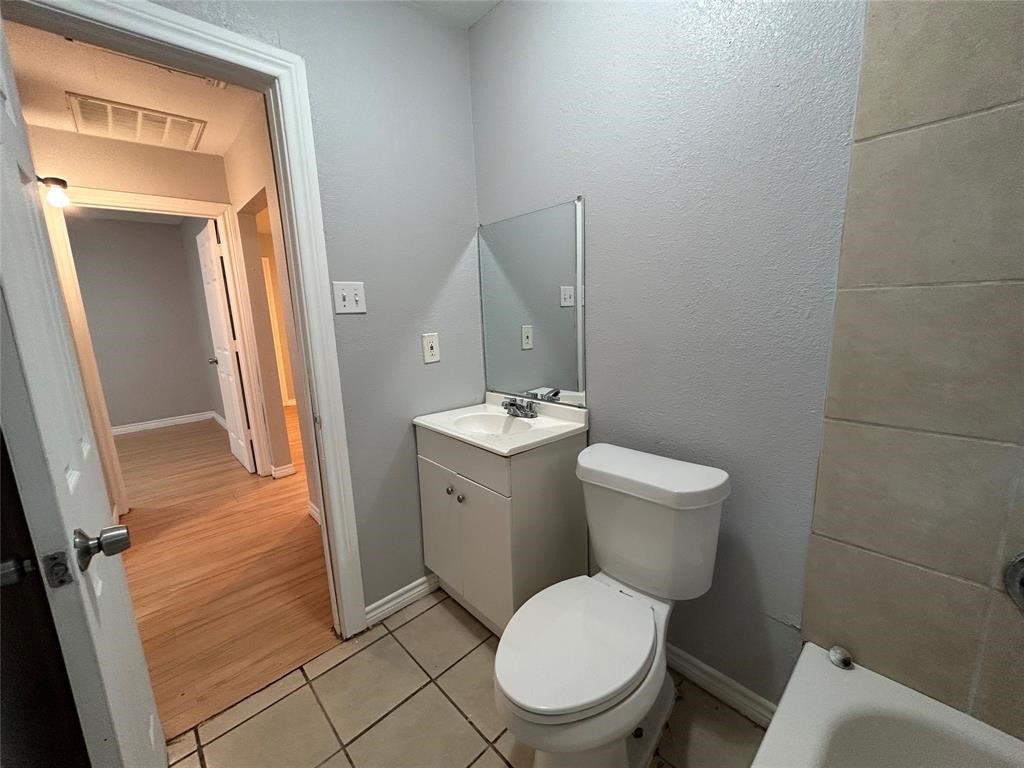 6818 Weston Street, Unit 1 Houston, TX 77021 - Photo 10 of 10 a white toilet sitting next to a bathroom sink