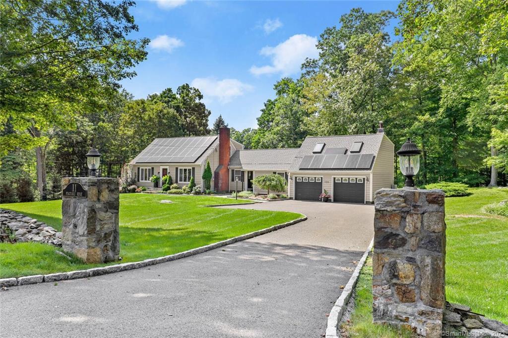 11 Peaceable Ridge Road Ridgefield, CT 06877 - Photo 1 of 1 a aerial view of a house next to a big yard and large trees