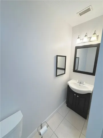 a bathroom with a sink mirror and toilet