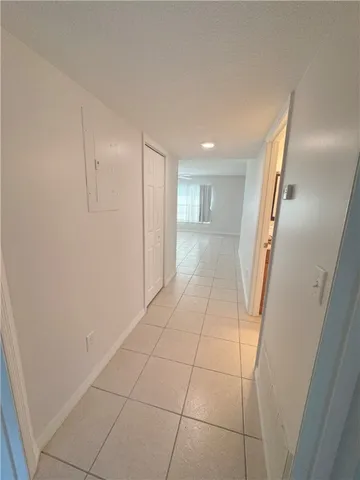 a view of a livingroom with an empty space and a hallway