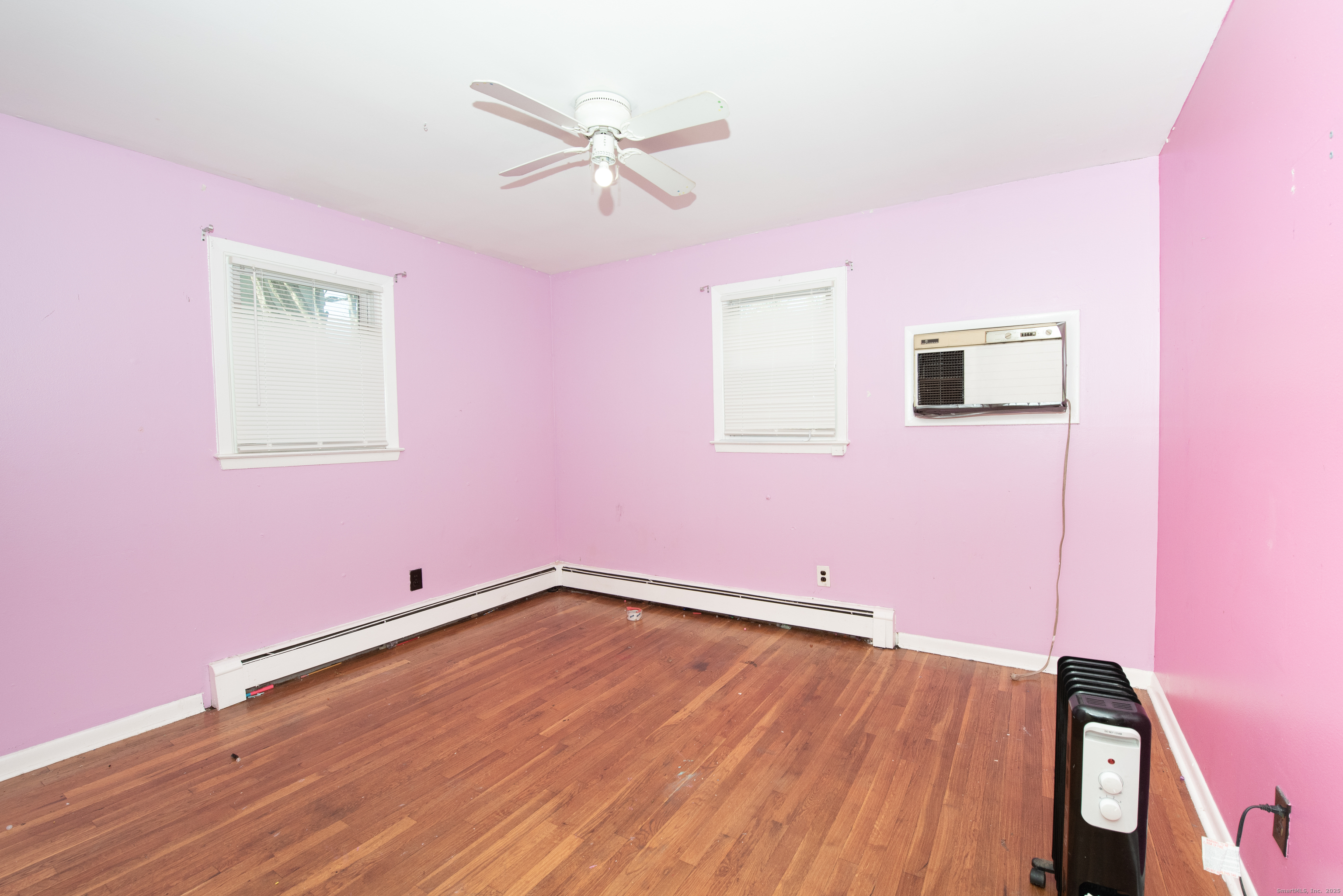 70 Pleasantview Avenue Bridgeport, CT 06606 - Photo 11 of 29 a view of room with hardwood floor and a ceiling fan