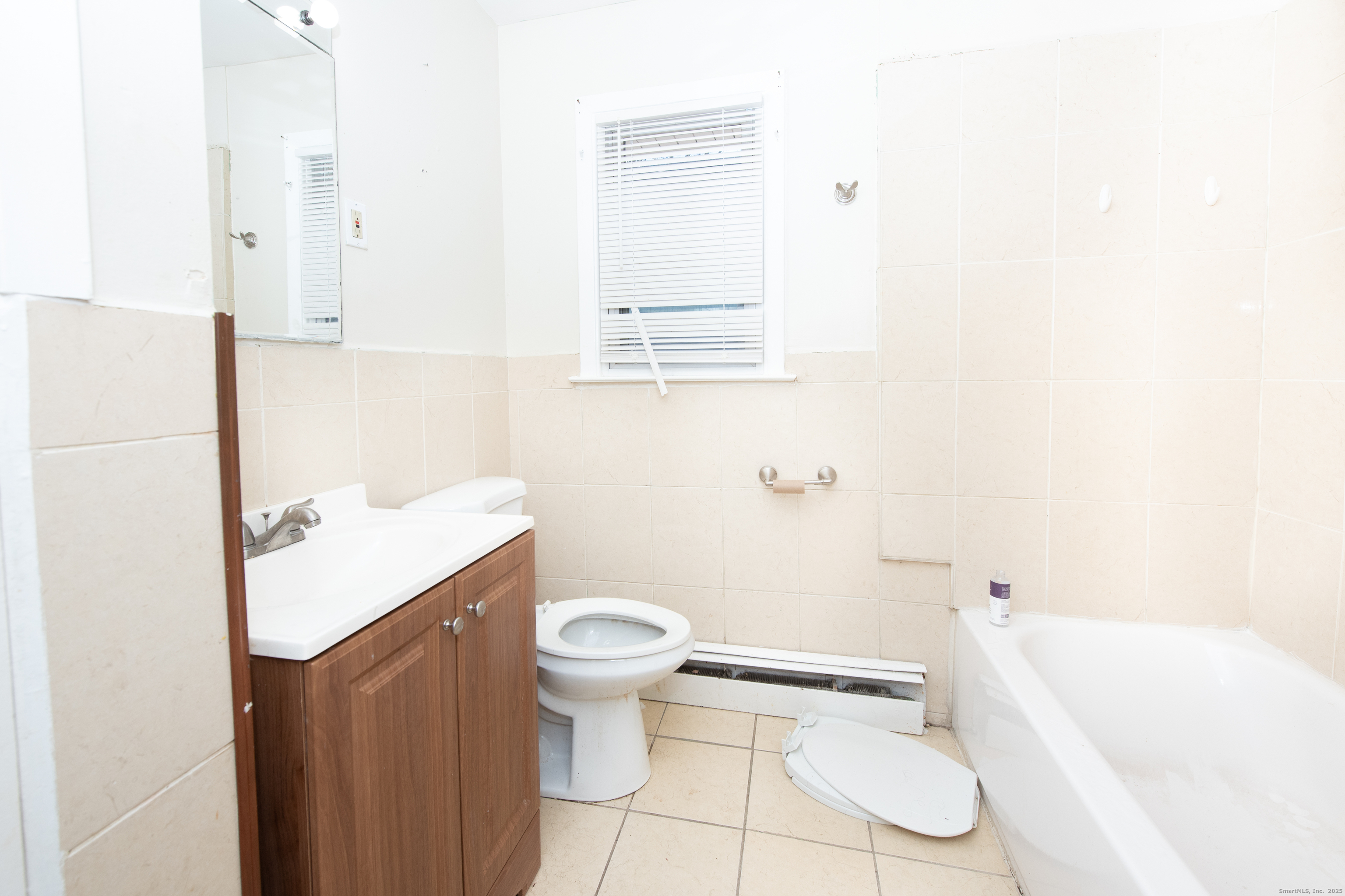 70 Pleasantview Avenue Bridgeport, CT 06606 - Photo 12 of 29 a bathroom with a sink a toilet and bathtub