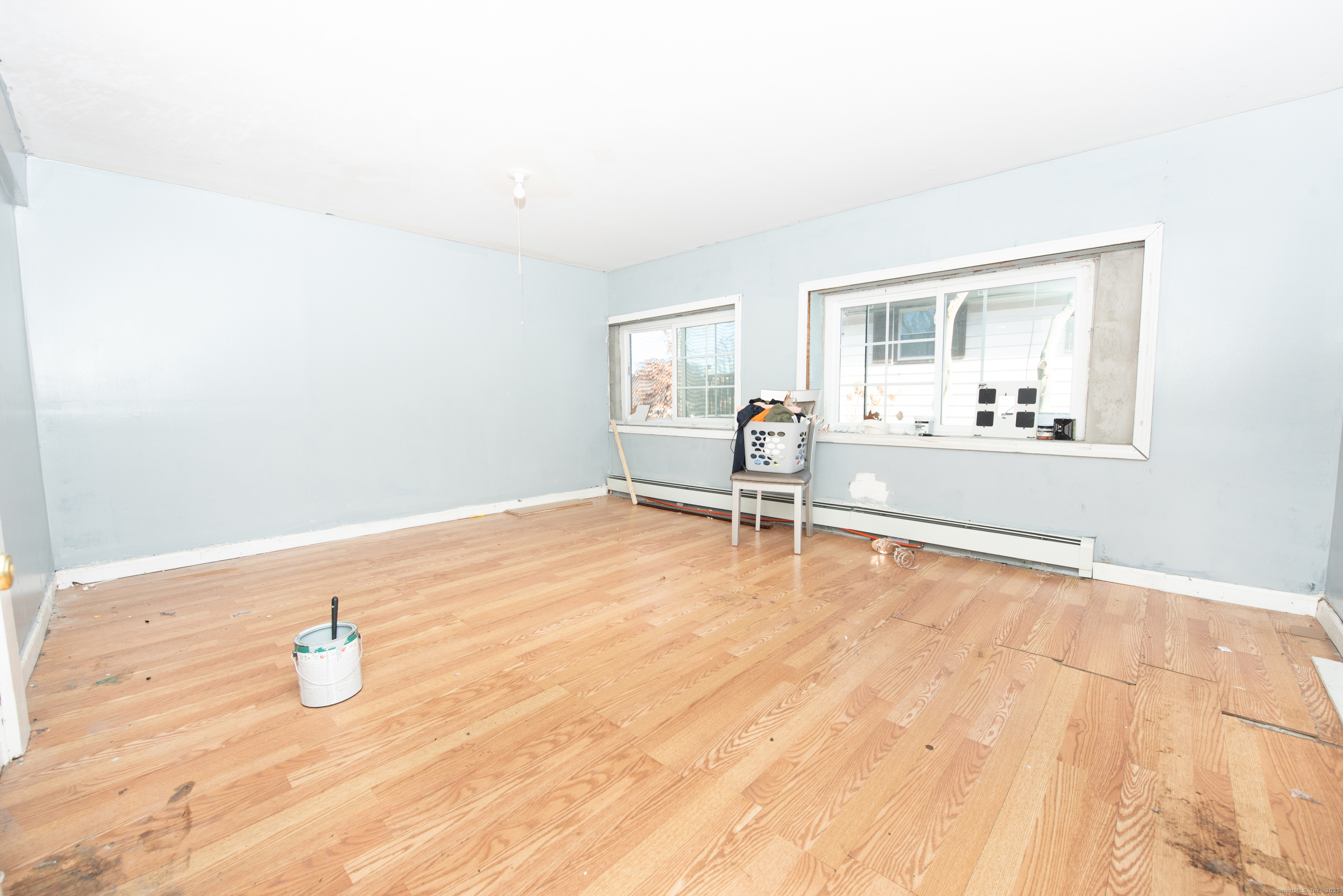 70 Pleasantview Avenue Bridgeport, CT 06606 - Photo 17 of 29 a view of an empty room with window and wooden floor