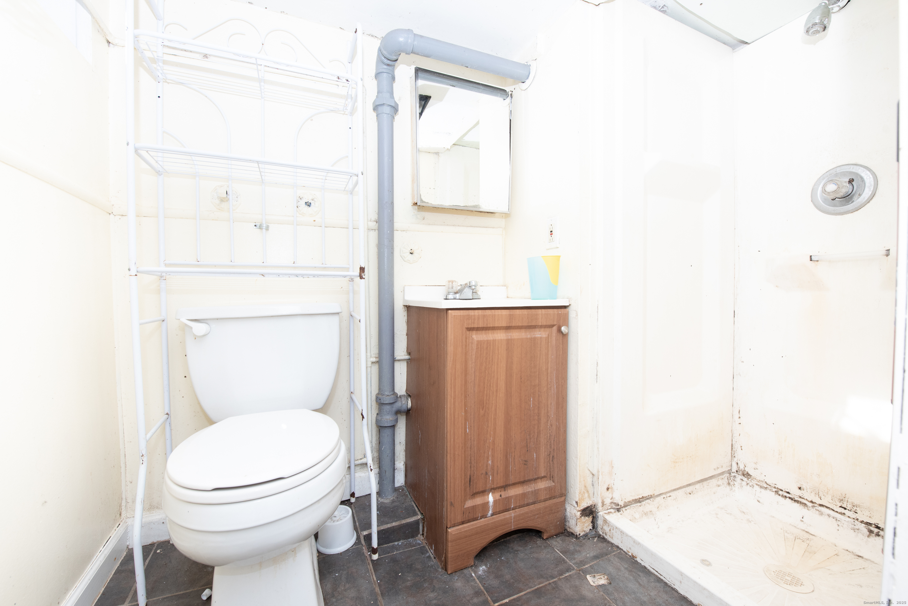 70 Pleasantview Avenue Bridgeport, CT 06606 - Photo 23 of 29 a bathroom with a toilet a sink and a window
