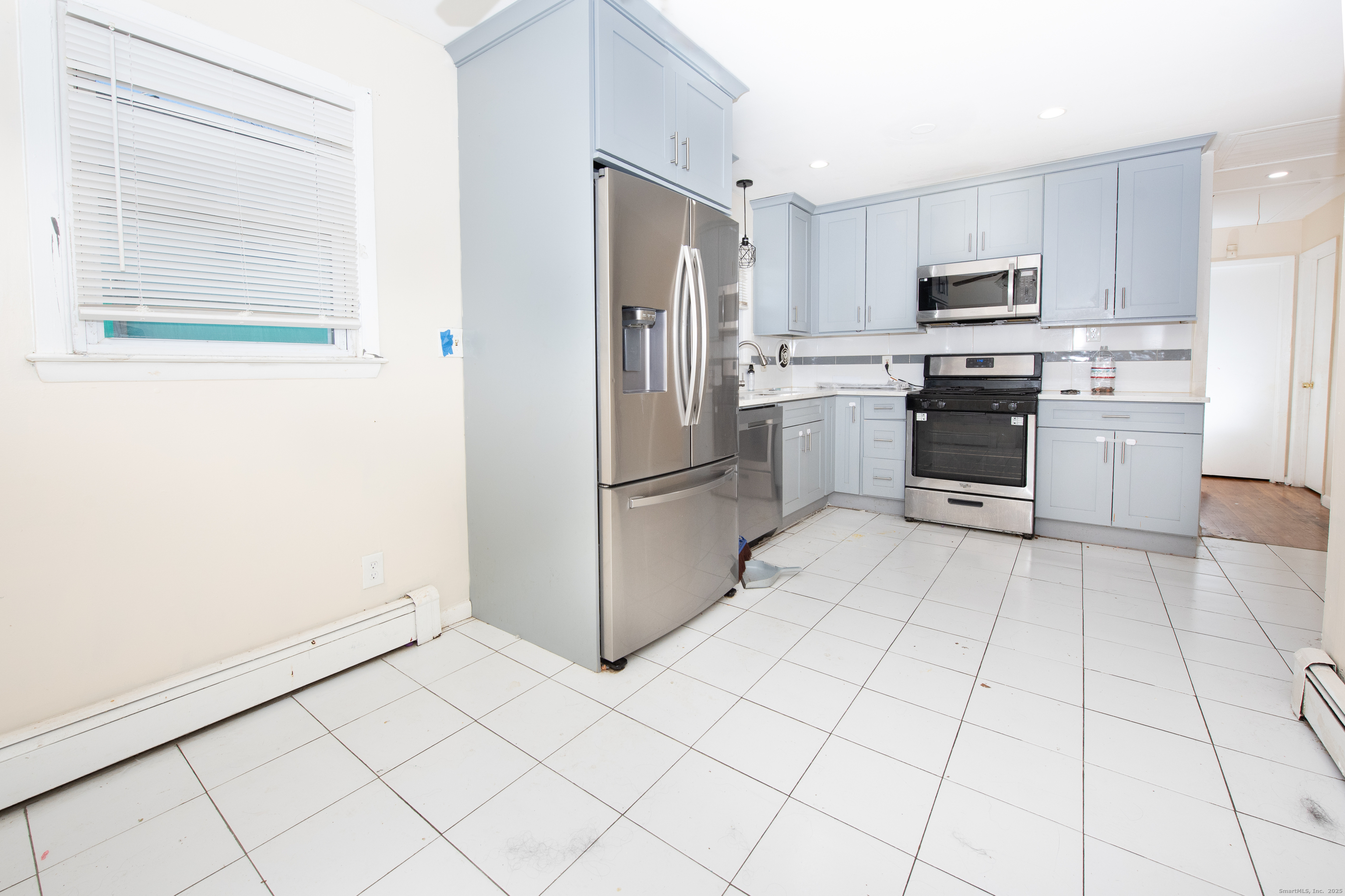 70 Pleasantview Avenue Bridgeport, CT 06606 - Photo 5 of 29 a kitchen with granite countertop a refrigerator and a stove top oven