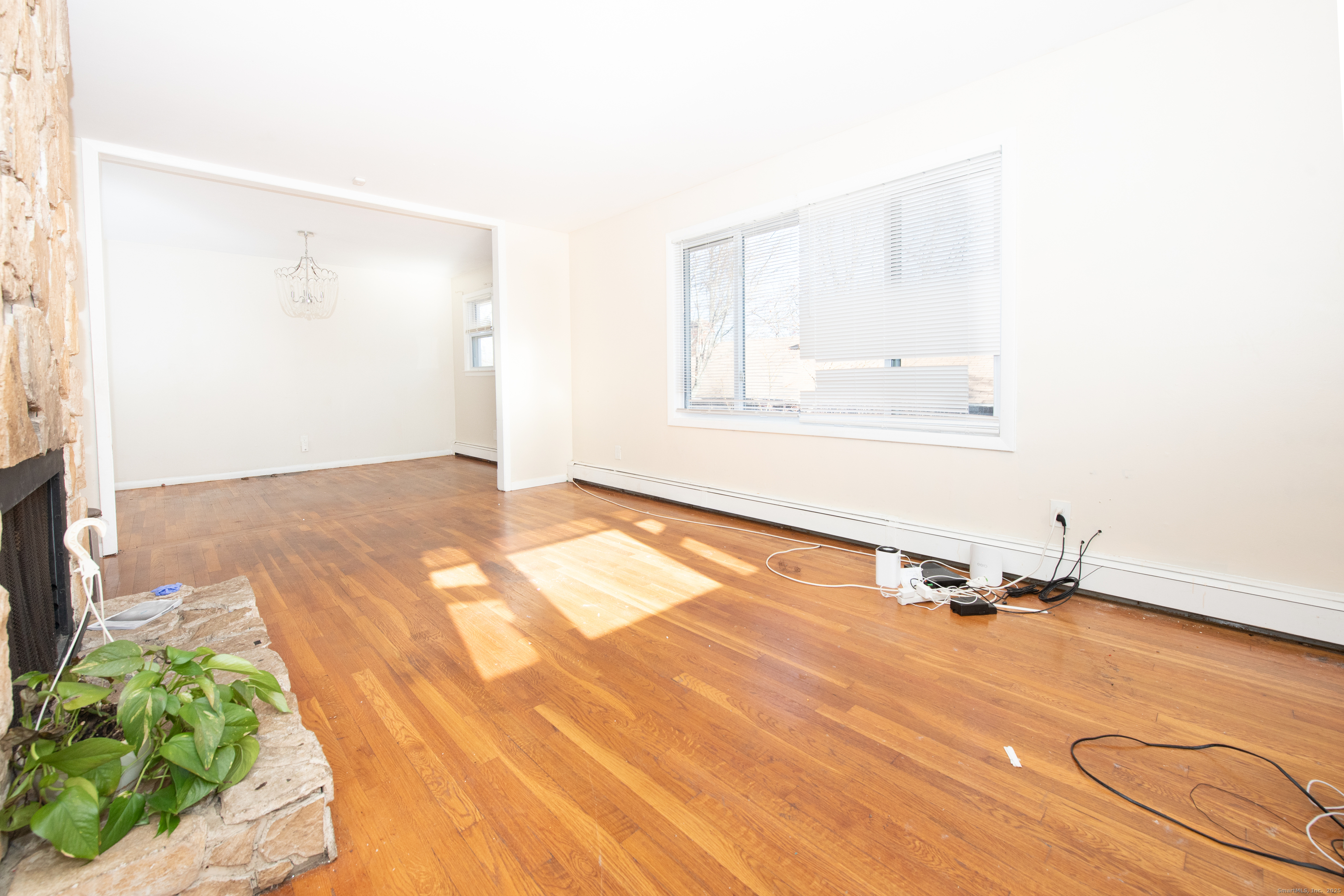 70 Pleasantview Avenue Bridgeport, CT 06606 - Photo 8 of 29 a view of a room with wooden floor and white walls