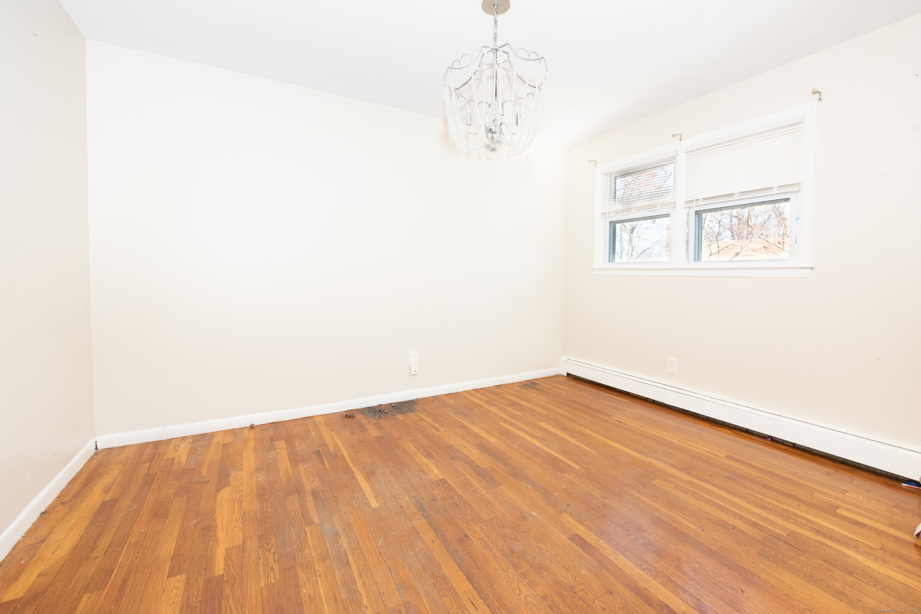 70 Pleasantview Avenue Bridgeport, CT 06606 - Photo 9 of 29 a view of empty room with wooden floor and fan