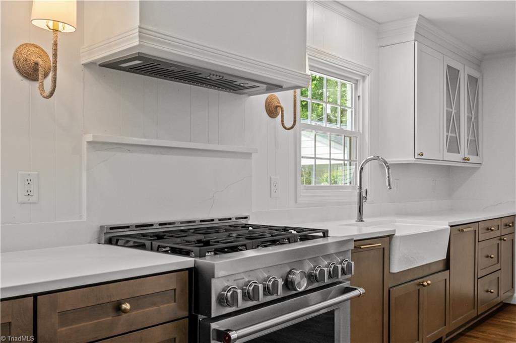 118 East Keeling Road Greensboro, NC 27410 - Photo 11 of 32 48" Commercial gas range with custom vent hood and hidden PANEL dishwasher with integrated garbage drawers.