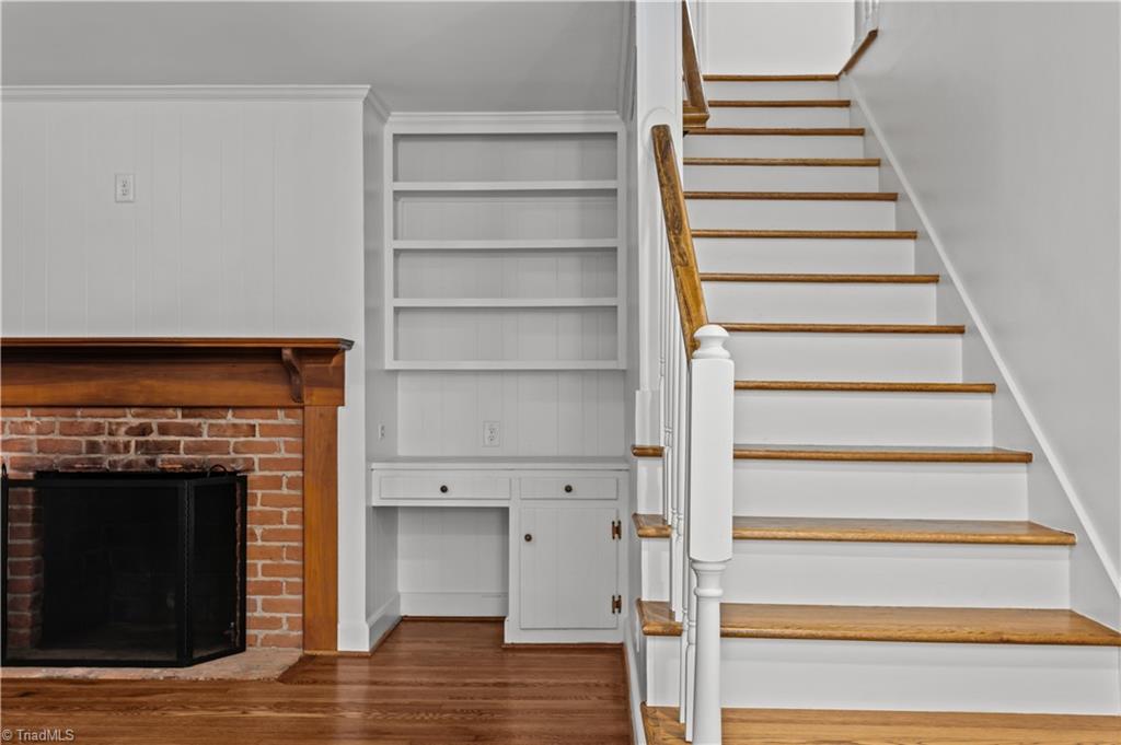 118 East Keeling Road Greensboro, NC 27410 - Photo 16 of 32 Original fireplace and surround, period built-ins and work-desk. Perfect blend of new AND original character. Integrated electrical for modern television placement.