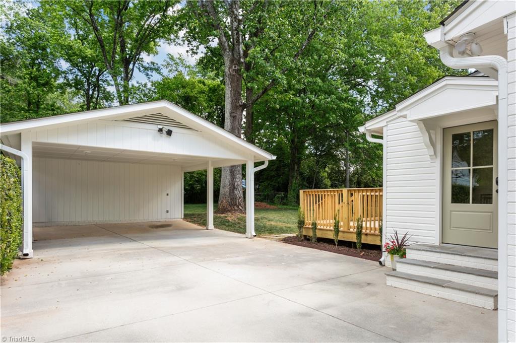 118 East Keeling Road Greensboro, NC 27410 - Photo 29 of 32 Not just covered parking but also AMPLE usable space in the back. Bluestone side entry stairs and brand new rear deck.