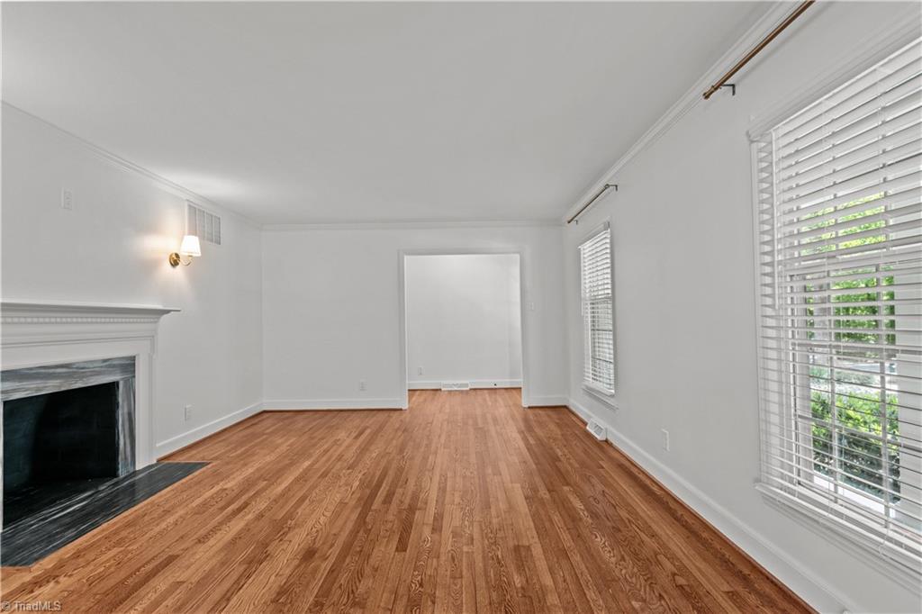 118 East Keeling Road Greensboro, NC 27410 - Photo 5 of 32 Stunning wood burning fireplace, refinished hardwood floors, denil molding fireplace surround, all new paint, and exceptional fixtures.