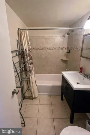 a bathroom with a bathtub and shower