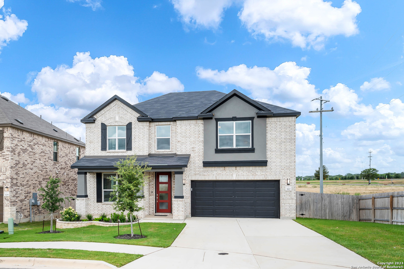 a front view of a house with a yard