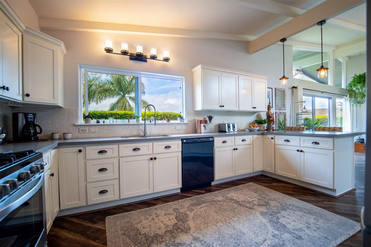 78 Ka Drive, Unit 1 Kula, HI 96790 - Photo 14 of 28 a kitchen with stainless steel appliances a white wooden cabinets and a stove top oven
