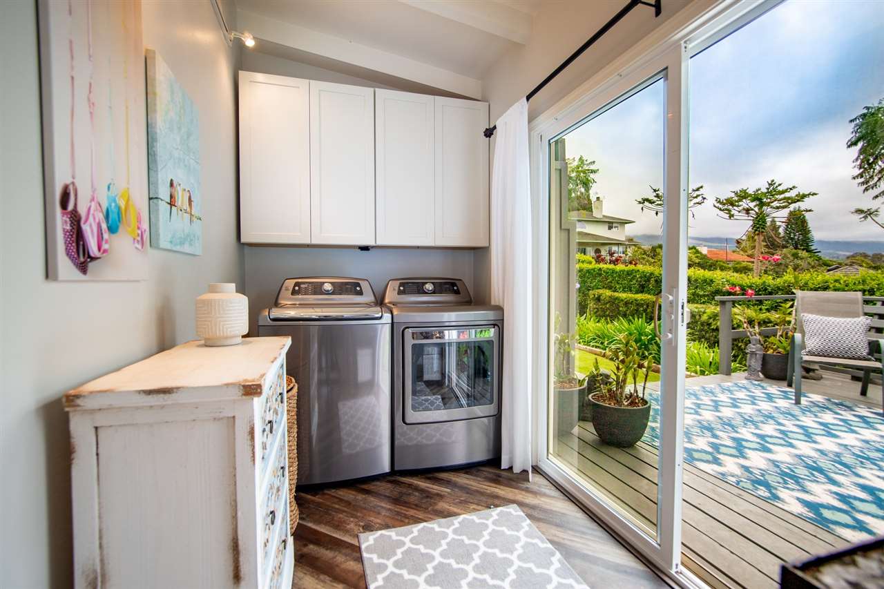 78 Ka Drive, Unit 1 Kula, HI 96790 - Photo 22 of 28 a utility room with stainless steel appliances a stove a window and a rug
