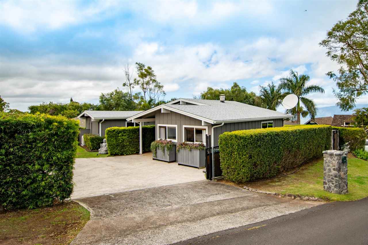 78 Ka Drive, Unit 1 Kula, HI 96790 - Photo 5 of 28 a front view of a house with a garden and trees