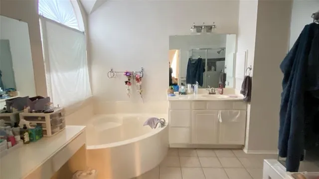 a bathroom with a tub sink and mirror