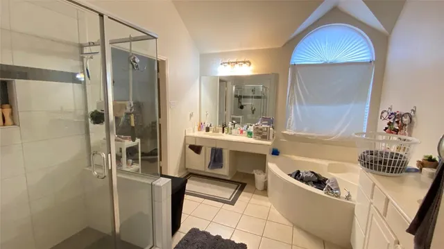 a bathroom with a tub sink and mirror