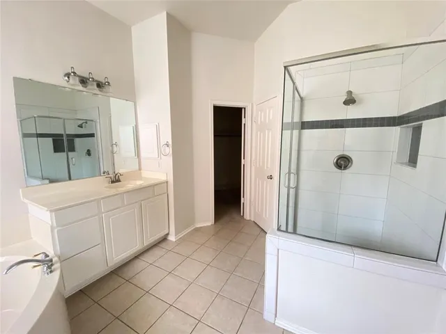 a bathroom with a double vanity sink a mirror a shower and vanity