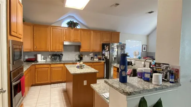 a kitchen that has a sink and a stove in it