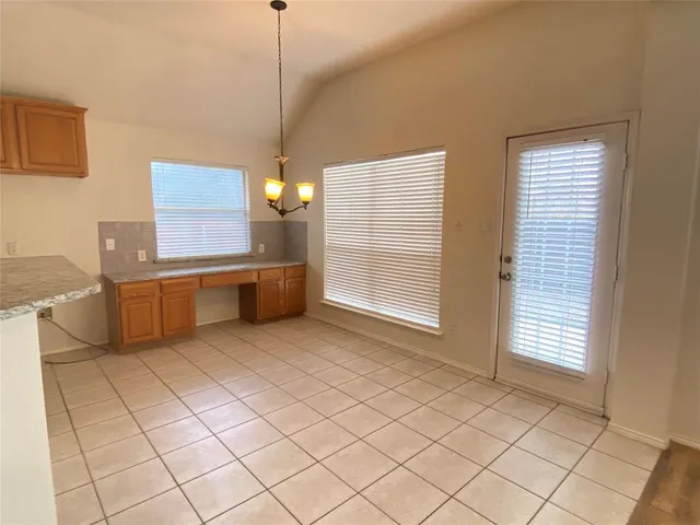 a view of a kitchen with furniture and cabinets