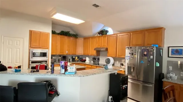 a kitchen with stainless steel appliances a refrigerator and a stove