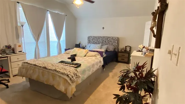 a bedroom with bed and window