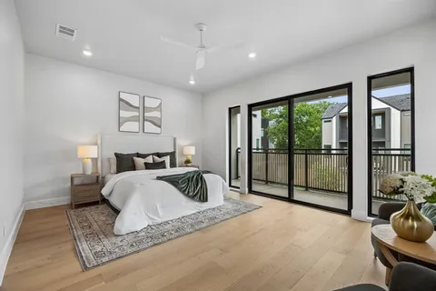 a spacious bedroom with a bed and glass windows