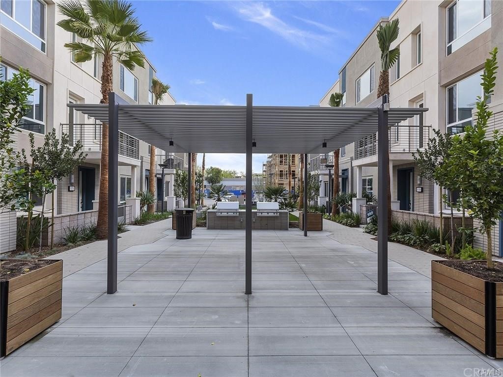 106 Citysquare Irvine, CA 92614 - Photo 18 of 21 a view of a patio with a table and chairs under an umbrella